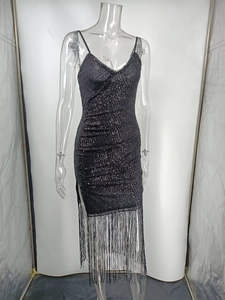 Detail shot of black sequin dress with long fringe hem and V-neckline on a studio model