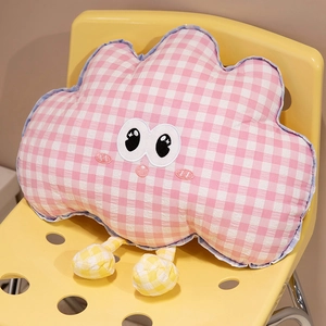 Pink plaid cloud plush pillow with cute embroidery and small yellow legs on a chair