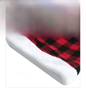 Detail of red and black buffalo plaid fabric and soft white plush trim on Christmas hat
