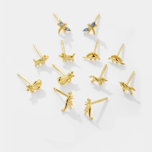 Macro shot of gold S925 sterling silver animal stud earrings with blue zircon stones