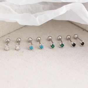 Detailed view of S925 silver star stud earrings with colorful crystals on textured fabric