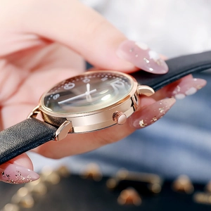 Gros plan d'une montre à quartz pour femme avec boîtier or rose et bracelet en cuir noir