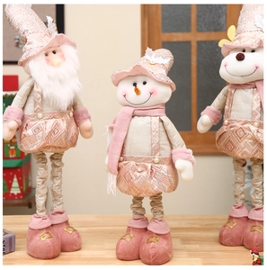 Close-up of pink and rose gold telescopic Christmas plushies with sequin and velvet details