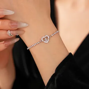 Sparkling zircon heart bracelet with Virgin Mary relief shown on a model's wrist