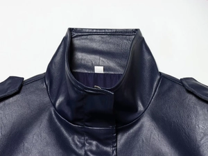 Macro shot of dark blue leather vest with high collar, epaulettes and litchi texture