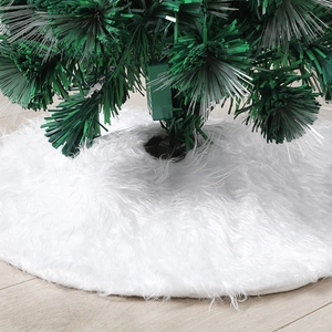 White faux fur Christmas tree skirt with plush texture on a wooden floor background