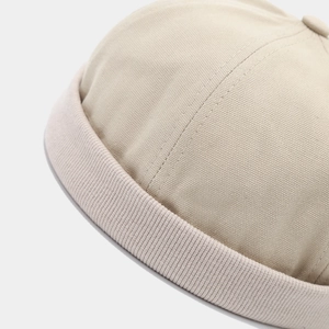 Detailed close-up showing the premium cotton stitching and texture of the beige miki hat
