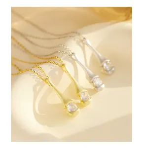 Macro shot of 925 silver necklaces with brushed matte finish and zircon waterdrop pendants
