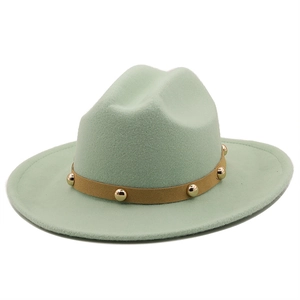 Detail of mint green wool fedora with brown leather band and gold metal studs