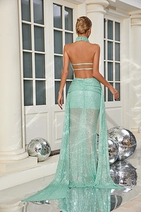 Detail of mint green sequin evening gown showing a backless design with crisscross straps