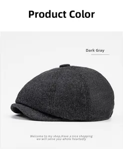 Detailed view of the dark grey wool newsboy cap showing textured fabric and top button