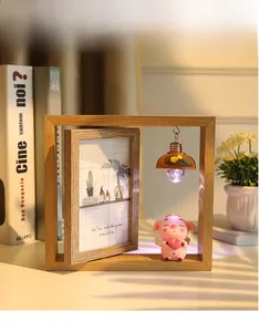 Détail d'un cadre photo rotatif en bois de 6 pouces avec ange cochon et mini lampe suspendue