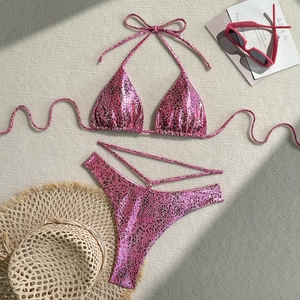 Detailed flat lay of pink leopard print bikini with neck ties and high-cut side straps