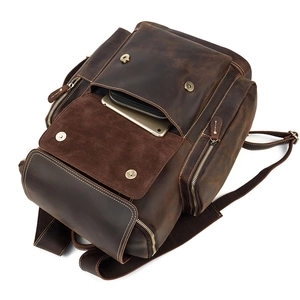 Macro detail of dark brown crazy horse leather backpack showing front pocket storage