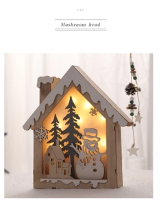 Detail of wooden Christmas reindeer lamp with warm LED light and laser-cut forest scene