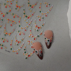 Detailed Christmas nail decals with festive red green dots and holiday light patterns