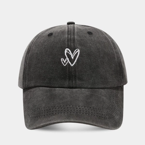 Vintage washed black cotton baseball cap featuring minimalist white heart embroidery