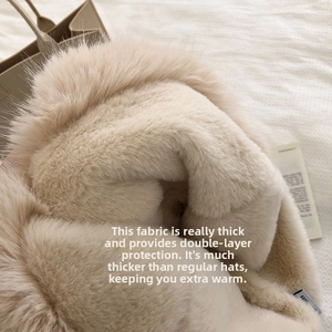 Detail of the thick double-layered plush fabric on this warm beige winter beanie hat