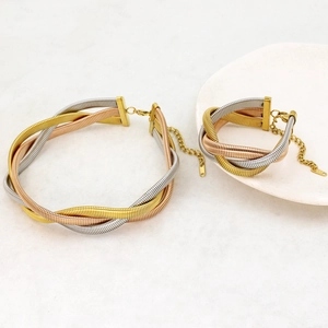 Detail of 18K gold-plated tri-color braided cable chain necklace and bracelet set