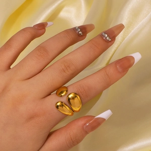 Polished gold stainless steel open ring with abstract triple teardrop design on hand