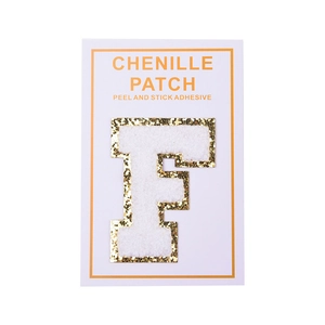 Detailed texture of white chenille letter F patch with gold glitter edge and peel adhesive