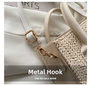 Detail of cream woven handbag showing golden adjustable buckle and leather shoulder strap