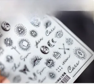 Detailed macro view of 5D nail art stickers featuring celestial sun and moon designs