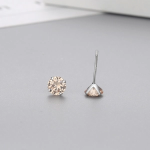 Detail view of S925 sterling silver stamp and champagne zircon on four-prong stud earring