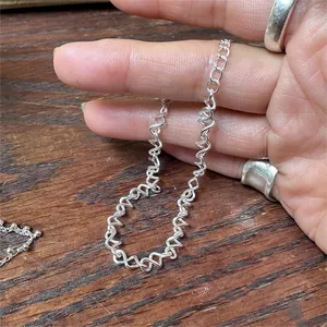 Detailed close-up of a 925 sterling silver twisted wave chain bracelet with high polish