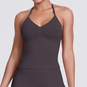 Close-up of seamless dark purple sports bra with halter neck and pleated chest detail