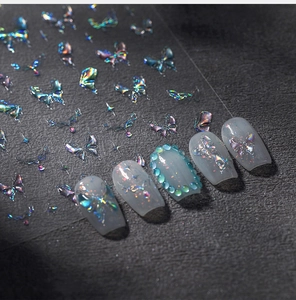 Close-up of holographic 3D butterfly nail stickers with metallic stars and relief details