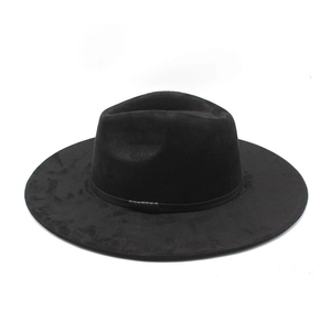 Detailed close-up of a black faux suede fedora hat featuring a wide flat brim and classic crown