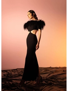 Detail of off-shoulder evening dress featuring luxury feather trim and side waist cut-outs