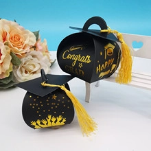 Detail of graduation candy box with black mortarboard design and gold congrats tassel