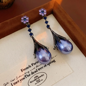 Vintage floral drop earrings with purple petals, blue crystals, and teardrop pearls