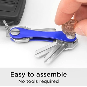 Blue metal key organizer being assembled with a coin to show no-tools-required feature