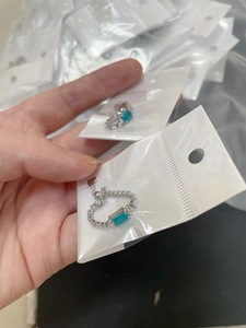 Detailed macro view of adjustable silver chain ring with a rectangle blue zircon stone