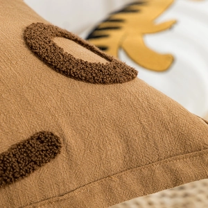 Modern brown towel embroidered throw pillow with circular textured pattern for sofa decor