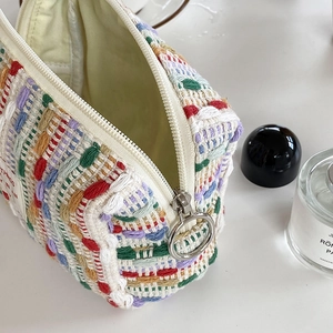 Colorful woven makeup bag with large metal ring zipper and spacious interior storage
