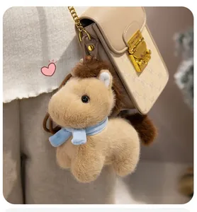 Cute plush horse keychain attached to a vintage monogram shoulder bag with gold hardware