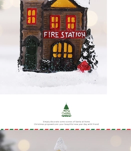 Detailed view of a miniature resin fire station with snow base and festive LED lights