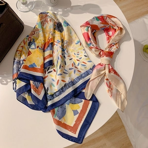 Detail of premium paisley silk scarf set with abstract patterns on a leather luxury bag