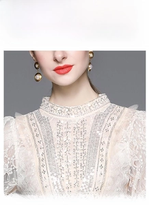Detailed view of the lace collar with intricate embroidery and sequins on the dress