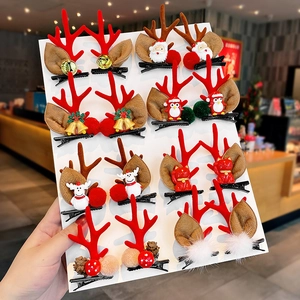 Set of 16 cute Christmas reindeer antler hair clips with festive charms on a card