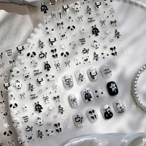 Black and white Christmas nail stickers with snowman and bow designs for holiday manicures