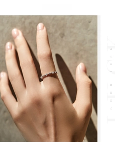 Detail shot of minimalist s925 silver irregular pave ring on a hand with soft lighting