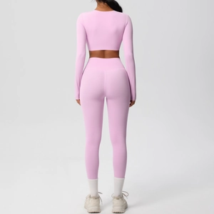 Back view of pink two-piece yoga set showing slim fit long sleeve top and high waist leggings