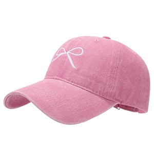 Pink washed cotton baseball cap featuring vintage finish and white bow embroidery