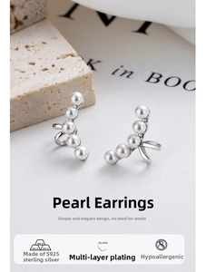 Detail of silver S925 sterling silver ear cuffs featuring five lustrous white pearls