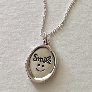 Vintage 925 sterling silver oval pendant necklace featuring smile engraving and thin chain